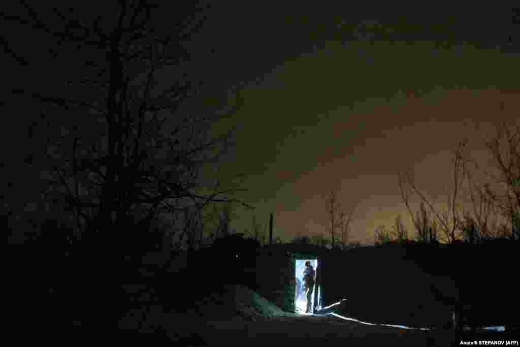 A Ukrainian soldier leaves a shelter on the front line with Russia-backed separatists near the village of Verkhnetoretskoye in the Donetsk region of eastern Ukraine.