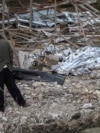 A man at the site of the aftermath of a Russian drone and missile strike in Ukraine's Lviv region on October 5, 2025.