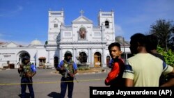 Sri Lankans gather outside St. Anthony's Shrine a day after a series of blasts in Colombo. Hundreds were killed in the April 21 attacks across the island nation.