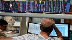 Stockbrokers react during trading hours at the Pakistan Stock Exchange in Karachi on April 13, as oil prices surged and stocks plunged following Trump's announced blockade of the Strait of Hormuz.