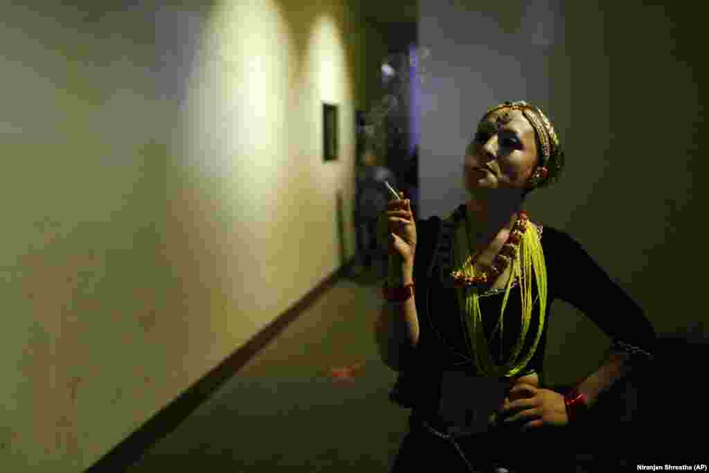 A Nepalese transgender person smokes a cigarette backstage during a Miss Pink pageant in Kathmandu on May 17. (AP/Niranjan Shrestha)