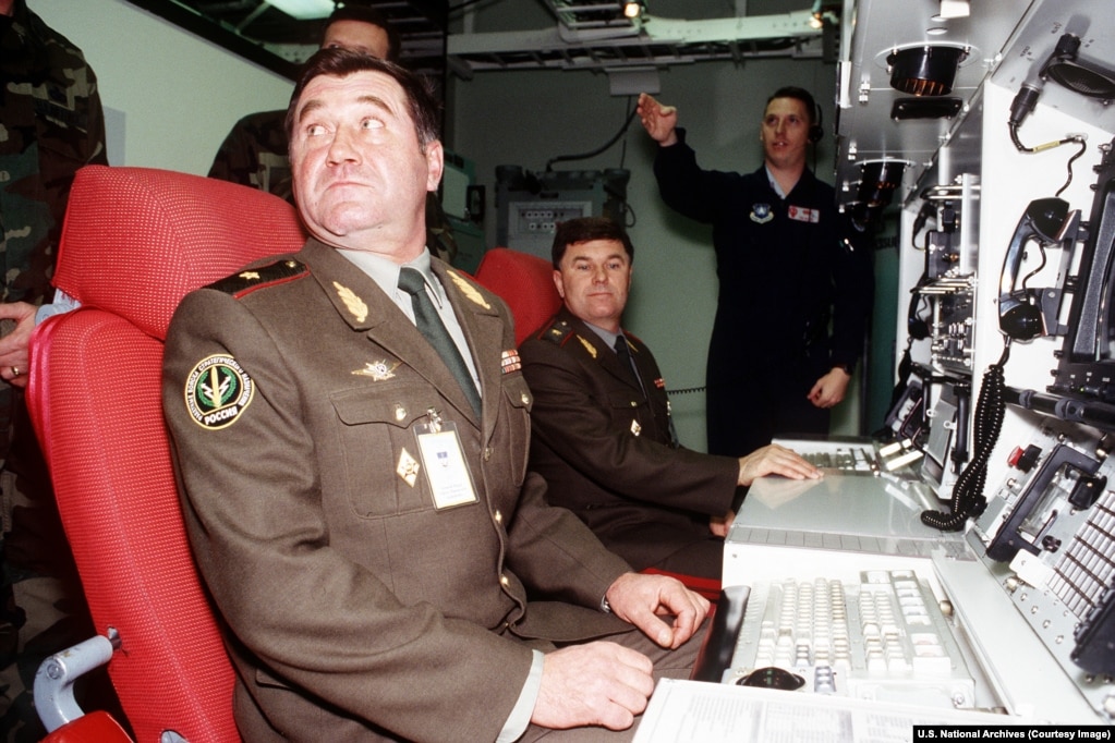 Two senior officers from Russia's Strategic Rocket Forces sit in the chairs of a U.S. nuclear missile simulator used for training.