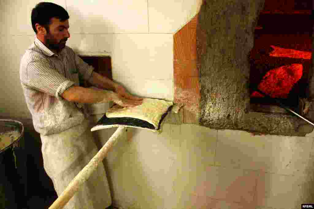 Bakers in Zanjan use a stone oven to make sangak, a type of plain white bread baked on a bed of pebbles. - In the city of Zanjan, northwest of Qom, many small businesses and craftspeople preserve the traditions they have kept for centuries. 