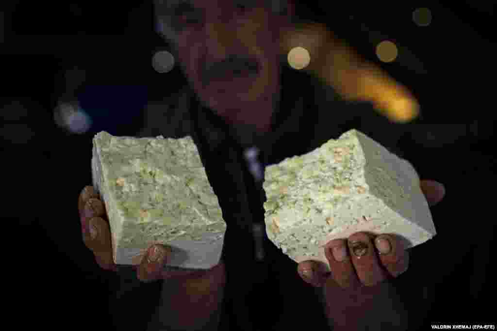 Bajram Balje holds traditional sheep cheese produced by his family. The distinctive taste comes from the plants and herbs that sheep consume in the highlands. Dill, which is a common plant in the area, affects the taste the most.