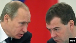 President Dmitry Medvedev (right) speaks with Prime Minister Vladimir Putin during a meeting of the Russian State Council on January 22.