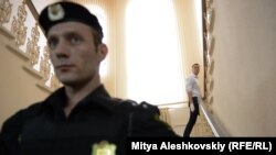 Alexei Navalnîi, în spatele poliţistului, urcând scările judecătoriei din Kirov