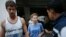 Anastasia Vashukevich (center) and Aleksandr Kirillov (left) arrive at the immigration detention center in Bangkok, Thailand, on February 28.