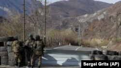 NAGORNO-KARABAKH -- Ethnic Armenian militants stand at a checkpoint near village of Charektar at a new border with Kalbacar district turned over to Azerbaijan, November 25, 2020