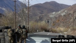 NAGORNO-KARABAKH -- Ethnic Armenian soldiers stand at a checkpoint near village of Charektar, November 25, 2020