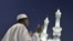 A Muslim pilgrim prays outside the Grand Mosque in Mecca, Saudi Arabia. Under King Abdullah, the kingdom has moved toward a more inclusive form of Islam.
