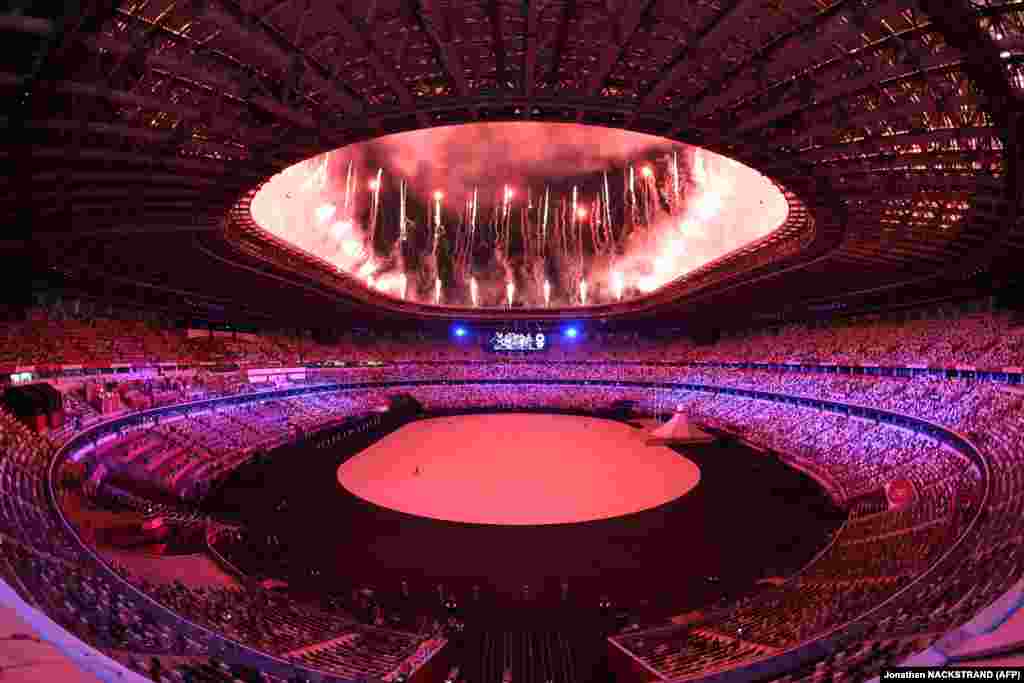 Fireworks go off around the Olympic Stadium during the opening ceremony of the Tokyo 2020 Olympic Games.