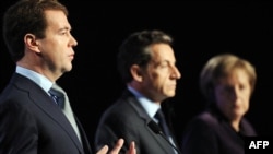 Two Poles: President Nicolas Sarkozy (center), his Russian counterpart Dmitry Medvedev, and German Chancellor Angela Merkel in Deauville, France