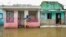 Dominican Republic - A man stands next to a house on a flooded street after the passing of the tropical storm Melissa before becoming a hurricane at Las Cucarachas neighborhood in Santo Domingo, Dominican Republic on October 28, 2025. 