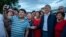 Almazbek Atambaev poses for a photo with supporters outside his compound in Koi-Tash on June 27.