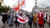 Belarusian pensioners carrying banned white-red-white flags and flowers parade through the streets of Minsk during a rally to demand the resignation of authoritarian leader Alyaksandr Lukashenka and a new fair election on October 19.