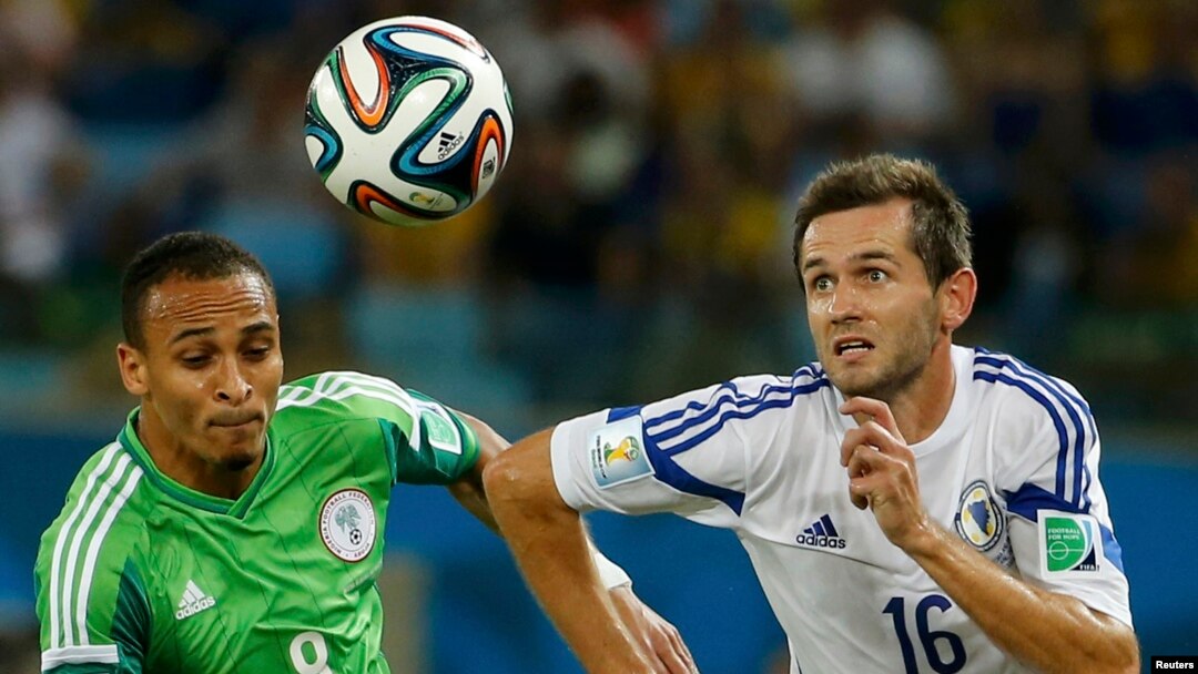 Nigeria's Peter Odemwingie (left) challenges for the ball with Bosnia's Senad Lulic during their 2014 World Cup Group F soccer match at the Pantanal arena in Cuiaba. 
