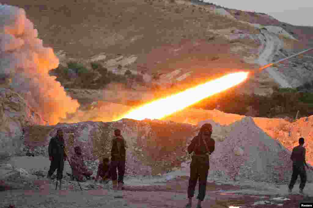 Free Syrian Army fighters launch a Grad rocket from Halfaya town in Hama Province toward forces loyal to Syria's President Bashar al-Assad. (Reuters/Ammar Abdullah)