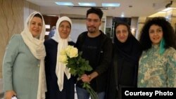 علی نوریزاد، فعال مدنی زندانی پس از رفتن به مرخصی در کنار مادرش و چند فعال مدنی دیگر