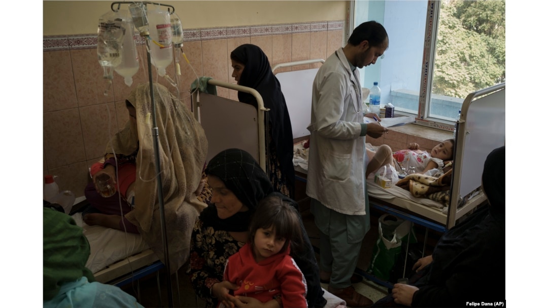 A doctor checks on a patient as others sit in a crowded room at Indira Gandhi Children's Hospital in Kabul on October 5.