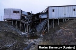 An industrial building collapses into a furrow left by thawing permafrost.