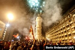 Supporters of the opposition VMRO-DPMNE party celebrate victory at the party's headquarters in Skopje late on October 31.