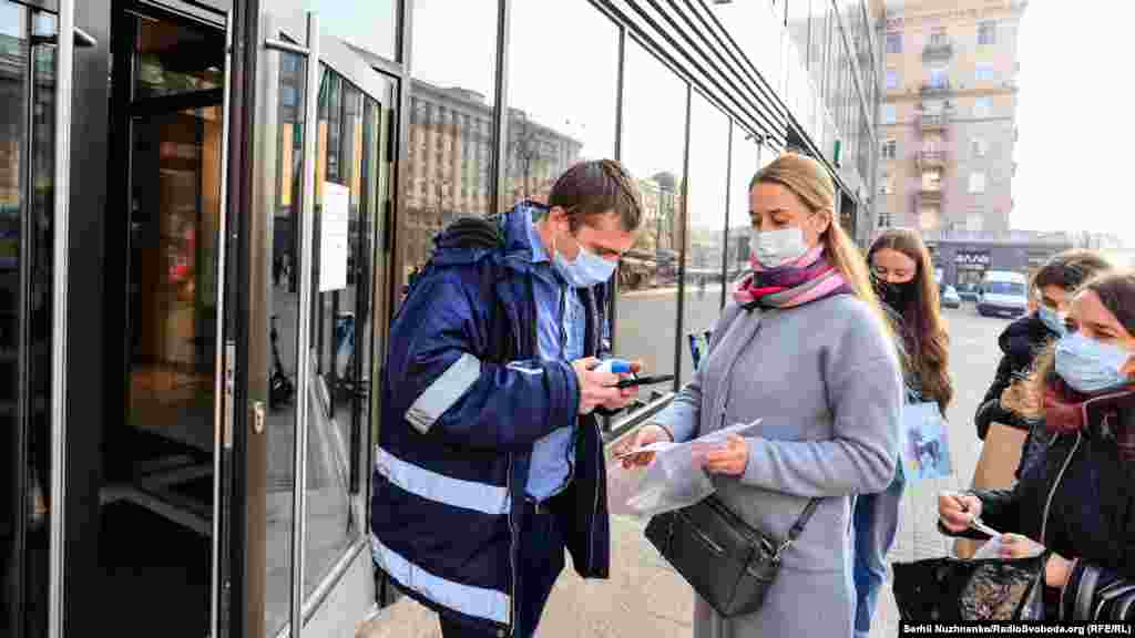 Police check vaccination certificates among passengers on public transport in Kyiv on November 1 amid new restrictions to stem a surge in COVID-19 infections and deaths attributed to low vaccination rates.