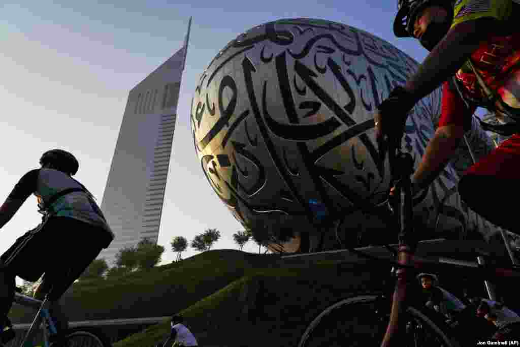 Bicicliști merg pe lângă Muzeul Viitorului și Turnurile Emiratelor din Dubai, Emiratele Arabe Unite, vineri, 5 noiembrie. În cursa anuală &bdquo;Dubai Ride&rdquo;, autoritățile au închis autostrada mărginită de zgârie-nori care străbate centrul orașului, pentru a permite bicicliștilor să circule pe ea. Organizatorii spun că 32.750 de persoane au participat vineri la cursă.