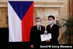 Taiwanese Foreign Minister Joseph Wu (right) is presented with a commemorative medal by Czech Senate speaker Milos Vystrcil during his 2021 visit to Prague.