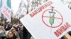 A placard reading "Vaccination Kills" is seen at a rally against compulsory vaccination for some state employees and to demand the lifting of restrictions imposed by the authorities to curb the spread of COVID-19 in Kyiv on November 3.