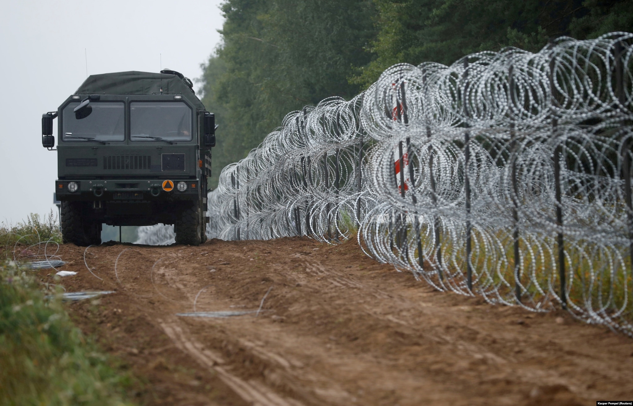A fence built by Polish soldiers on the border between Poland and Belarus near the village of Nomiki, Poland.