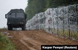 A fence built by Polish soldiers on the border between Poland and Belarus near the village of Nomiki, Poland.