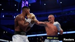 Oleksandr Usyk lands a punch on Anthony Joshua in their world title fight in London on September 25. 