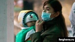 A woman wears a mask to protect herself against the flu in Bishkek.