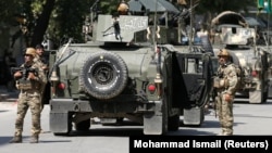 Afghan security forces arrive at the scene of an attack in Kabul on May 9.