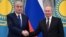 Kazakh President Qasym-Zhomart Toqaev (left) and Russian President Vladimir Putin shake hands during a joint news conference following their talks at the Kremlin in Moscow on February 10, 2022, two weeks before Moscow's full-scale invasion of Ukraine.