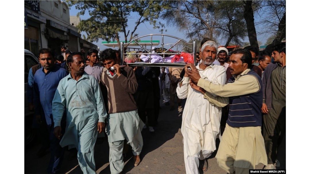 Relatives and locals carry a coffin containing the body of Muhammad Mushtaq for his funeral at Khanewal district on February 13.