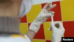 A medical specialist prepares a dose of Sputnik M vaccine against COVID-19 at a clinic in Nizhny Novgorod in February. 