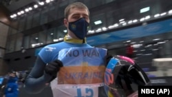 Vladyslav Heraskevych flashed the small sign in the blue and yellow colors of the Ukrainian flag on February 11.