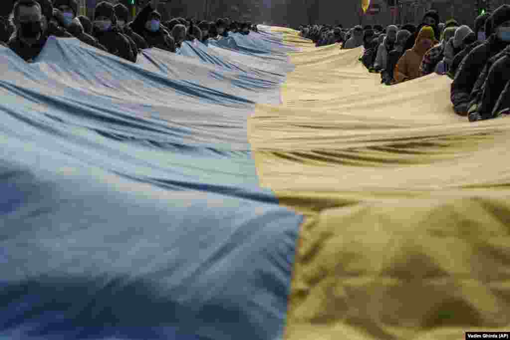 People carry a large Ukrainian national flag, marking the Day of Unity in Sievierodonetsk in the Luhansk region of eastern Ukraine