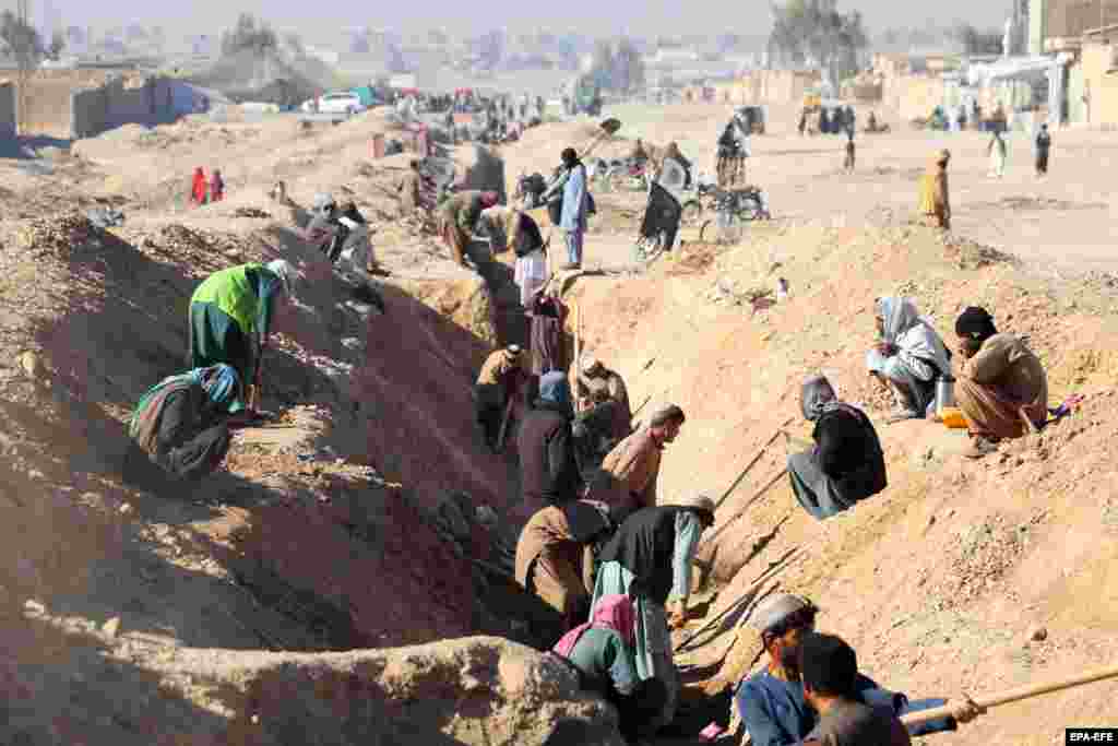 Afghan laborers work on two flood protection canals, marking the first largest project in Kandahar since the Taliban&#39;s takeover of Afghanistan. Beside providing opportunities to 1,000 people, the two canals&nbsp; -- 1,300 meters and 950 meters in length -- will serve to protect several residential areas and villages from seasonal floods in a district of the provincial capital, Kandahar city.