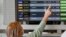 Israel - A woman checks the departures board for the flight to Kyiv before boarding at Israel's Ben Gurion airport in Lod near Tel Aviv on February 13, 2022