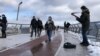 Overlooking the Dneipr River, and stretching between Saint Volodymyr Hill and the People's Friendship Arch, the three-year-old Glass Bridge is a popular tourist destination for tourists and buskers. Despite the looming threat of war, few residents of Kyiv