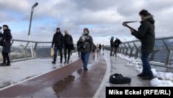 Overlooking the Dniepr River, and stretching between St. Volodymyr Hill and the People's Friendship Arch, the 3-year-old Glass Bridge is a popular destination for tourists and buskers.