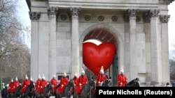 Članovi konjice prolaze pored Wellington Archa i velikog srca na Dan zaljubljenih u Londonu, Velika Britanija, 14. februara 2022.