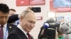 Russian President Vladimir Putin visits an exhibition at the Harbin Institute of Technology in Harbin as part of a 2024 state visit to China. 