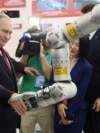 Russian President Vladimir Putin visits an exhibition at the Harbin Institute of Technology in Harbin as part of a 2024 state visit to China. 