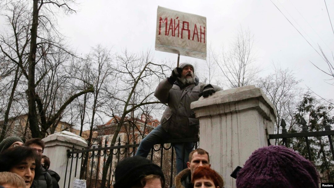A protester holds a placard that reads "Maidan" outside a courthouse in Moscow on February 24.