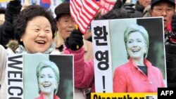 South Korean conservatives welcome the visit of U.S. Secretary of State Hillary Clinton outside the US Embassy in Seoul.