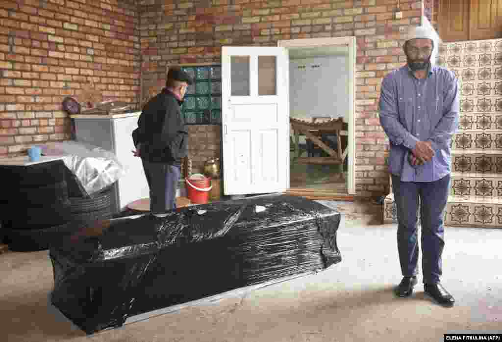 A coffin with the body of Ibragim Todashev sits in his family home in the Chechen capital, Grozny. Todashev was shot dead by the FBI during questioning in Florida about his possible links to the Boston Marathon bombers. (AFP/Elena Fitkulina)