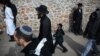 Ukraine -- Orthodox Jewish pilgrims walk on the street during celebration Rosh Hashana in Uman city, about 200 km South of Kyiv, September 24, 2014